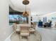 Breakfast nook with glass-top table and wicker chairs, overlooking pool at 1014 Francesca Ct, Punta Gorda, FL 33950