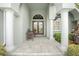 Covered front porch with tiled flooring, a bench, and columns at 1014 Francesca Ct, Punta Gorda, FL 33950