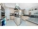 Modern kitchen with island, stainless steel appliances, and light wood cabinetry at 1014 Francesca Ct, Punta Gorda, FL 33950