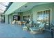 Spacious patio with wicker furniture, ceiling fan, and pool access at 1014 Francesca Ct, Punta Gorda, FL 33950