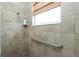 Walk-in shower with grab bar and tiled walls at 1014 Francesca Ct, Punta Gorda, FL 33950