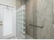 Walk-in shower with glass block wall and grab bar at 1014 Francesca Ct, Punta Gorda, FL 33950