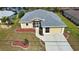 Single-Gathering home with landscaped yard and attached garage, aerial view at 110 Albatross Rd, Rotonda West, FL 33947