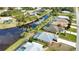 Aerial view of canal-front homes and lush landscaping at 110 Albatross Rd, Rotonda West, FL 33947
