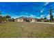 One-story house with landscaped yard and driveway at 110 Albatross Rd, Rotonda West, FL 33947