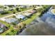 Aerial view showcasing a waterfront property with neighboring homes at 110 Albatross Rd, Rotonda West, FL 33947