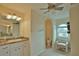 Bathroom with toilet, sink, and vanity, and a relaxing chair at 110 Albatross Rd, Rotonda West, FL 33947