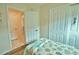 Bright bedroom with twin beds, built-in closet, and access to another room at 110 Albatross Rd, Rotonda West, FL 33947