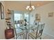 Bright dining room with glass table and access to a patio at 110 Albatross Rd, Rotonda West, FL 33947