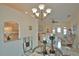 Elegant dining area with glass table, chairs, and a chandelier at 110 Albatross Rd, Rotonda West, FL 33947