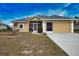 Tan house with gray roof, screened porch, and two-car garage at 110 Albatross Rd, Rotonda West, FL 33947