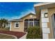 Tan house with gray roof and screened porch at 110 Albatross Rd, Rotonda West, FL 33947
