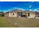 Tan house with gray roof, screened porch, and two-car garage at 110 Albatross Rd, Rotonda West, FL 33947