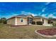 Tan house with gray roof, screened porch, and two-car garage at 110 Albatross Rd, Rotonda West, FL 33947