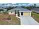 Single-story home with attached garage and landscaped yard at 110 Albatross Rd, Rotonda West, FL 33947