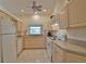 Galley style kitchen with light wood cabinets, and view to backyard at 110 Albatross Rd, Rotonda West, FL 33947