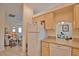 Well-equipped kitchen with white appliances and light wood cabinets at 110 Albatross Rd, Rotonda West, FL 33947