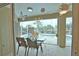 Enclosed lanai with pool view, decorated with butterflies at 110 Albatross Rd, Rotonda West, FL 33947