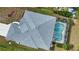 Screened kidney-shaped pool with concrete decking at 110 Albatross Rd, Rotonda West, FL 33947