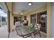 Relaxing screened porch with seating and glass table at 110 Albatross Rd, Rotonda West, FL 33947