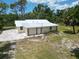 Single story home with metal roof and spacious backyard at 1136 Davis Ln, Englewood, FL 34224