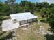 Single story home with metal roof and spacious backyard at 1136 Davis Ln, Englewood, FL 34224