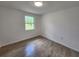 Bright bedroom with tile floors and a window with garden view at 1136 Davis Ln, Englewood, FL 34224