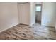 Bedroom with double door closet and wood-look tile floors at 1136 Davis Ln, Englewood, FL 34224