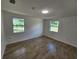 Spacious bedroom with tile floors and two windows at 1136 Davis Ln, Englewood, FL 34224