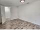 Spacious bedroom with wood-look tile floors at 1136 Davis Ln, Englewood, FL 34224