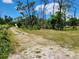 Long private driveway leading to a single story home at 1136 Davis Ln, Englewood, FL 34224