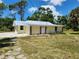 Newly remodeled single story home with metal roof and stone accents at 1136 Davis Ln, Englewood, FL 34224