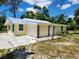 Newly remodeled single story home with metal roof and stone accents at 1136 Davis Ln, Englewood, FL 34224