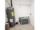 Laundry room with water heater and shelving at 1136 Davis Ln, Englewood, FL 34224