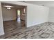 Spacious living room with wood-look tile floors at 1136 Davis Ln, Englewood, FL 34224