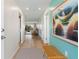 Bright entryway with light wood floors and teal accent wall at 1345 Mediterranean Dr # A204, Punta Gorda, FL 33950