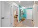 Condo entryway, featuring wood floors and a teal accent wall at 1345 Mediterranean Dr # A204, Punta Gorda, FL 33950