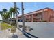 Condo building's exterior showcasing parking and landscaping at 1345 Mediterranean Dr # A204, Punta Gorda, FL 33950