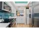Updated kitchen with white cabinets and teal tile at 1345 Mediterranean Dr # A204, Punta Gorda, FL 33950