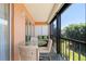 Spacious screened lanai with glass-top table and seating for four at 1345 Mediterranean Dr # A204, Punta Gorda, FL 33950