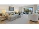 Relaxing living room with sectional sofa and access to balcony at 1345 Mediterranean Dr # A204, Punta Gorda, FL 33950