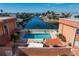 Community pool with patio furniture and canal views at 1345 Mediterranean Dr # A204, Punta Gorda, FL 33950
