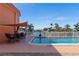 Community pool with patio furniture and shade structure at 1345 Mediterranean Dr # A204, Punta Gorda, FL 33950