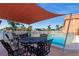 Community pool area with shaded seating for six at 1345 Mediterranean Dr # A204, Punta Gorda, FL 33950