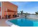 Community pool with patio furniture and shade structure at 1345 Mediterranean Dr # A204, Punta Gorda, FL 33950