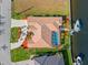Bird's-eye view of a home with screened-in pool, private dock, and lush landscaping at 1346 Osprey Dr, Punta Gorda, FL 33950
