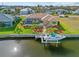 Aerial view of waterfront home, boat dock, and screened-in pool at 1346 Osprey Dr, Punta Gorda, FL 33950