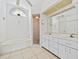 Bright bathroom featuring a soaking tub, tiled floors, double sinks, and a separate shower at 1346 Osprey Dr, Punta Gorda, FL 33950