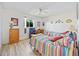 Bedroom with two striped beds, wood-look floors, ceiling fan, and window at 1346 Osprey Dr, Punta Gorda, FL 33950