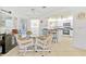 Open concept dining area with wicker chairs and a glass table next to kitchen at 1346 Osprey Dr, Punta Gorda, FL 33950